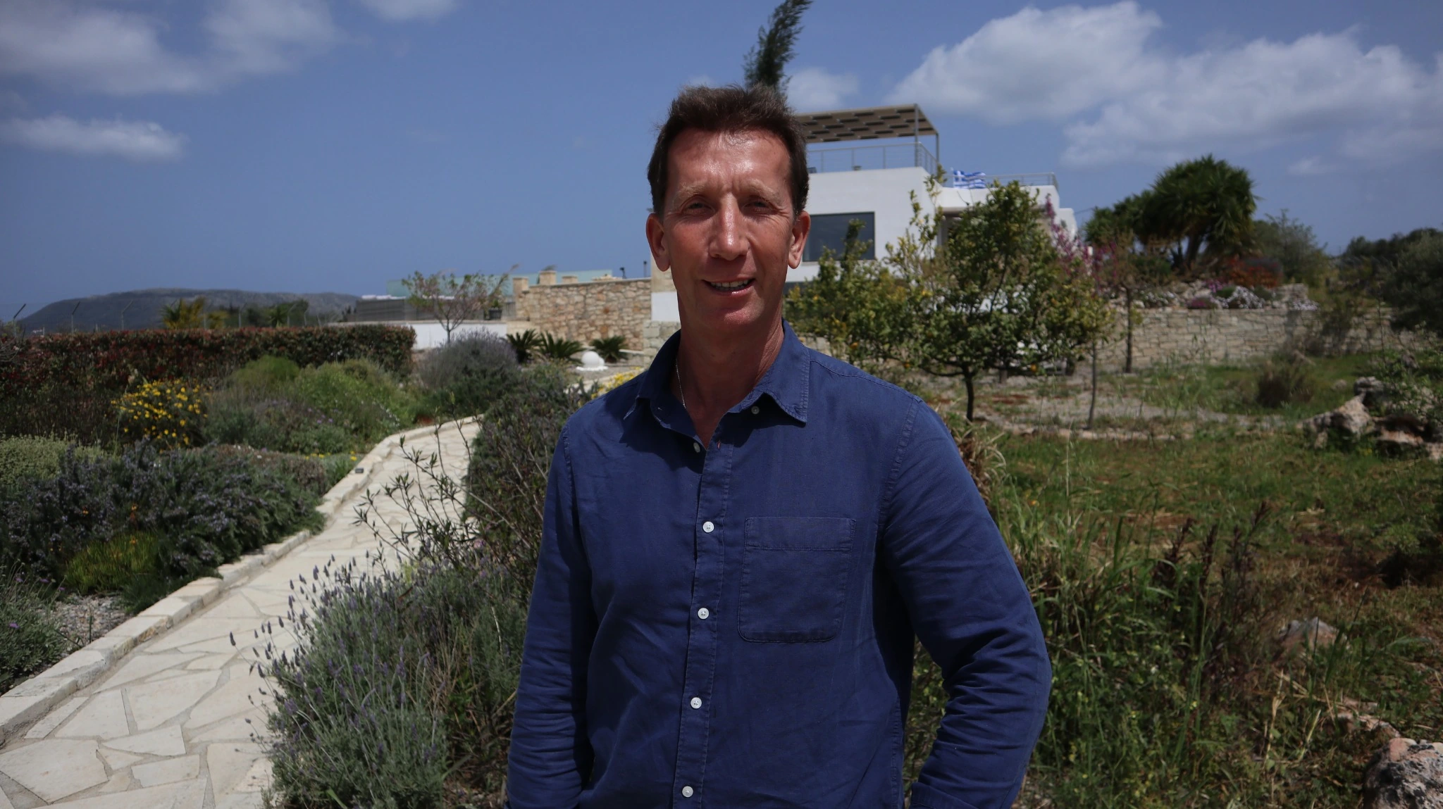 Portrait of Craig Alexander Rattray in a dark blue shirt