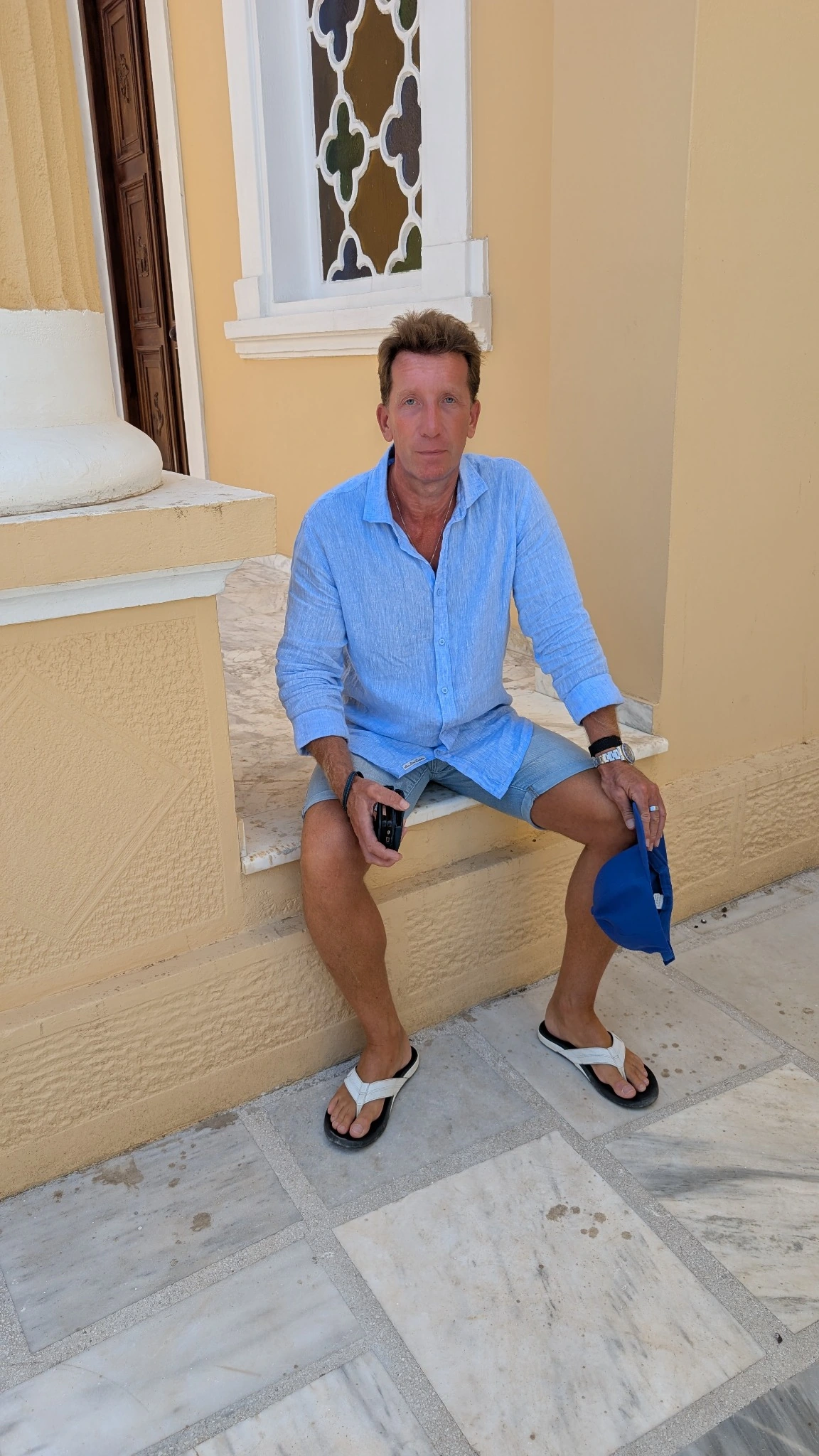 Craig Alexander Rattray seated outside in a light blue shirt